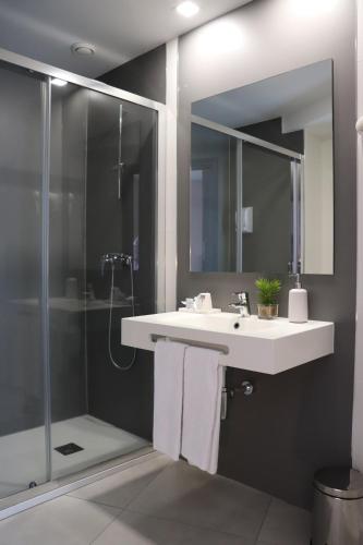 a bathroom with a sink and a shower at HOTEL ARZÚA in Arzúa