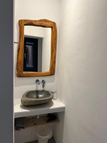 a bathroom with a sink and a mirror at The Coast Suites in Tourlos