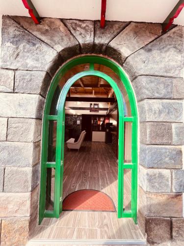 an archway in a stone wall with a living room at La Posada de Elisea - Mongui in Monguí