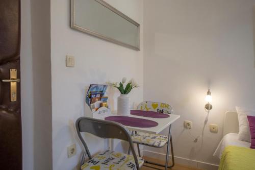 a room with a table and a chair and a bed at Old Town Historic Core in Split