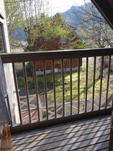 a screened in porch with a view of a yard at Hot Spring Resort Usui Pass Forest Park "Natural H - Vacation STAY 60419v in Karuizawa