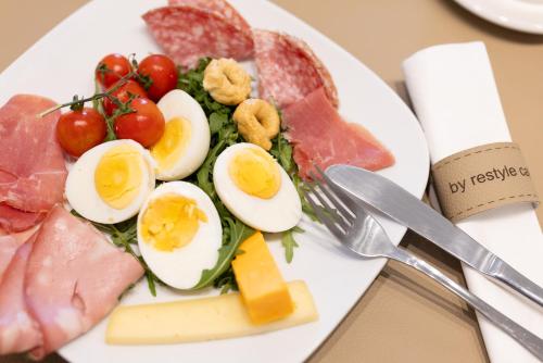 a plate of food with eggs and meats and cheese at C'est La Vie Boutik Swieqi in Is-Swieqi