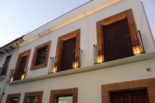 a building with a bunch of windows with lights at Centrico House in Taxco de Alarcón