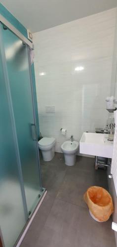 a bathroom with two toilets and a sink and a shower at B&B Del Maresciallo in Leporano