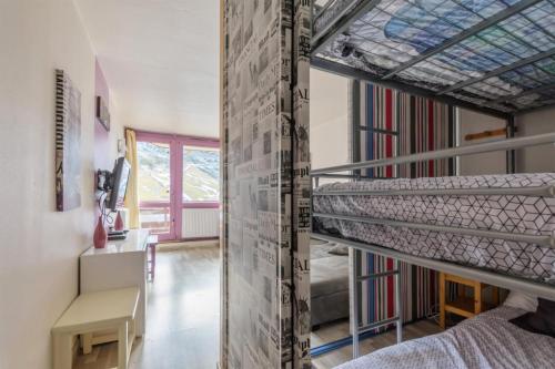 um quarto com um beliche e uma escada em Studio accès direct aux pistes à la Mongie 84848 em La Mongie
