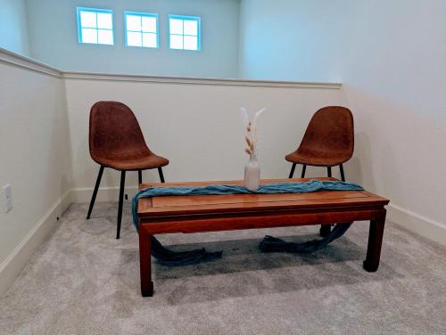 two chairs and a table with a vase on it at Modern, Spacious & Relaxing Home in Sparks, NV in Sparks