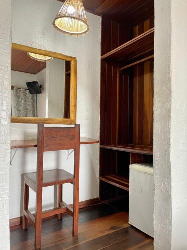 a dressing room with a wooden table and a mirror at Hotel Salinopolis e kitepoint in Salinópolis