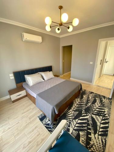 a bedroom with a bed and a rug at Luxury Beach Living in Mountain View in Ras Elhekma