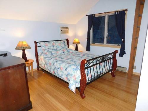 a bedroom with a bed and two lamps and a window at Where Memories Are Made in West Kill