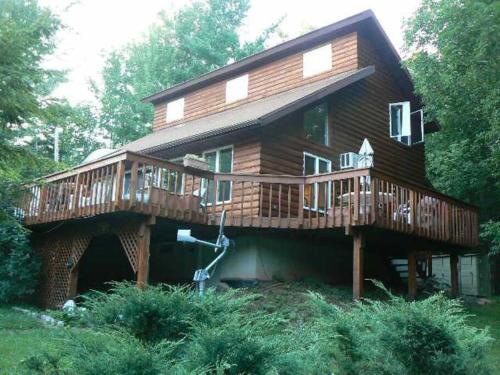 a large wooden house with a large deck at Where Memories Are Made in West Kill