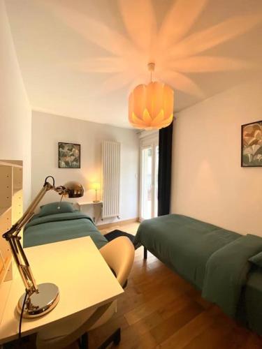 a bedroom with two beds and a lamp on a table at The villa of the Impressionists in Vernon