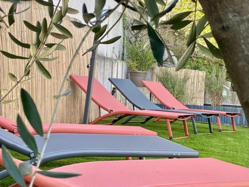 a row of colorful chairs sitting in the grass at The villa of the Impressionists in Vernon