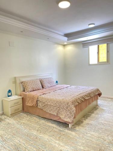 a bedroom with a large bed and a window at السحاب in Abha