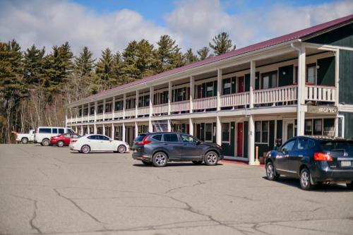 a large building with cars parked in a parking lot at Briarwood motor inn in Lincoln
