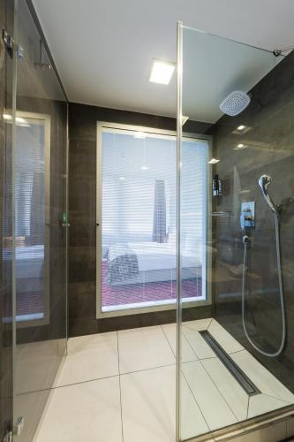 a bathroom with a shower with a glass door at Hotel Bayer's in Munich