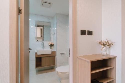 a bathroom with a toilet and a sink at Mini Jung Yama in Chiang Mai