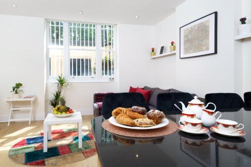 a table with a plate of pastries on it at 2 bedroom flat in Pimlico & Westminster in London