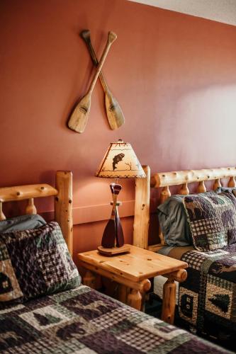 a room with two beds and a table with a lamp at Briarwood motor inn in Lincoln