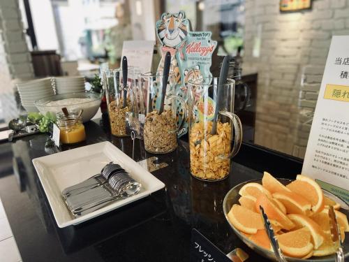 a table with snacks and a plate of food at Court Hotel Shin-Yokohama in Yokohama