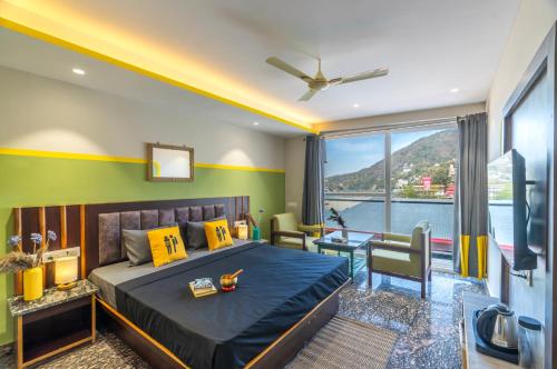 a bedroom with a bed and a view of the water at The Hosteller Rishikesh, Ganges in Rishīkesh