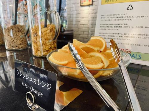 a bowl of orange slices sitting on a counter at Court Hotel Shin-Yokohama in Yokohama