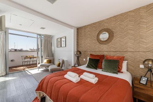 a bedroom with a large bed with two towels on it at BNBHolder Luxury Triplex CHAMBERI in Madrid