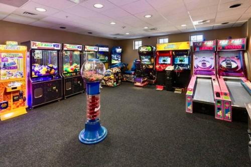 a room with several video game machines in a room at BOHO Bungalow on the Pond w/ Hot Tub in Arnolds Park