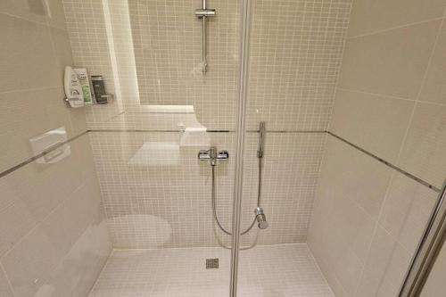 a shower with a glass door in a bathroom at Manavgat - Superb 2 bedroom apartment near beach and Side centre in Side