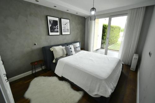 a bedroom with a large white bed and a window at Manavgat - Superb 2 bedroom apartment near beach and Side centre in Side