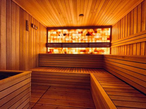 an empty sauna with wooden walls and a window at Hanami Design Hotel in Belgrade
