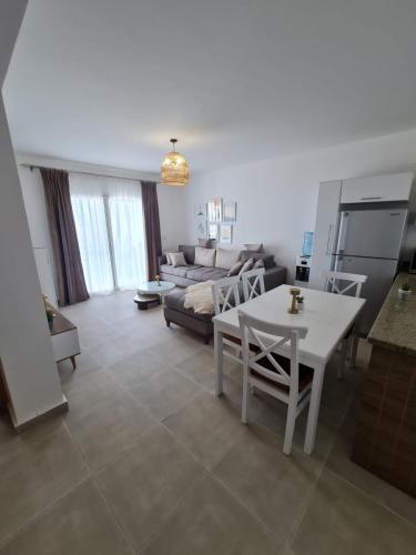 a living room with a white table and a couch at Sahel 3BR chalet Mountian view North coast Ras Elhekma in Zāwiyat al ‘Awwāmah