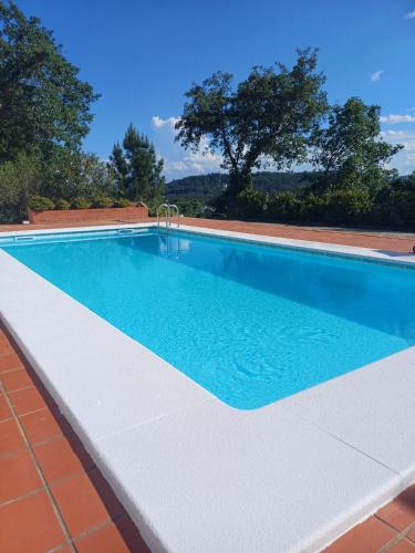 a swimming pool in a house with a blue at Fátima-Ourém - Quinta da Luz - breakfast included in Ourém