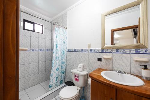 a bathroom with a toilet and a sink at La Peregrina Galapagos B&B in Puerto Ayora