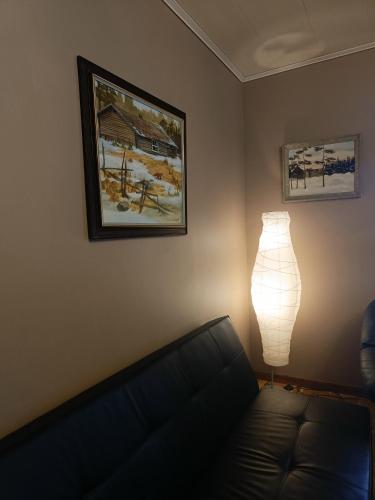 a living room with a couch and a lamp at Nordic character in Vidsel