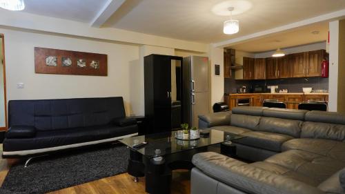 a living room with a couch and a table at The Swanky Apartment Manchester in Manchester