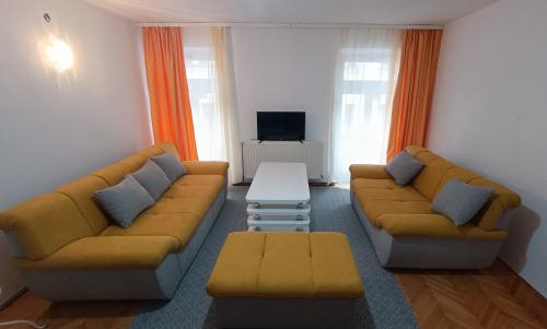 uma sala de estar com um sofá e uma mesa em Ferhadija Apartment em Sarajevo
