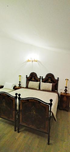 a bed in a room with two lamps on tables at Villa Mazzini in Molinella