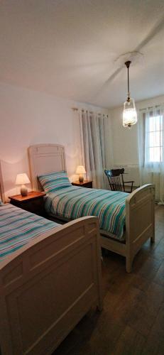 a bedroom with two beds and a table at Villa Mazzini in Molinella