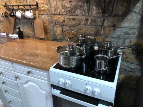 a stove with three pots on top of it at Kuća Mitića in Pirot
