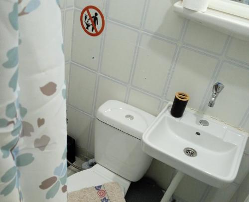 a bathroom with a white toilet and a sink at Frini Apartments and Studios in Paralia Katerinis