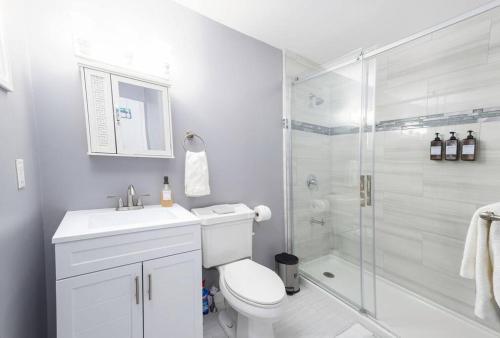 a white bathroom with a toilet and a shower at Convenient Braintree Home - 3 Bedroom Sleeps 8 in Braintree