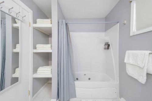 a white bathroom with a shower and a tub at Convenient Braintree Home - 3 Bedroom Sleeps 8 in Braintree