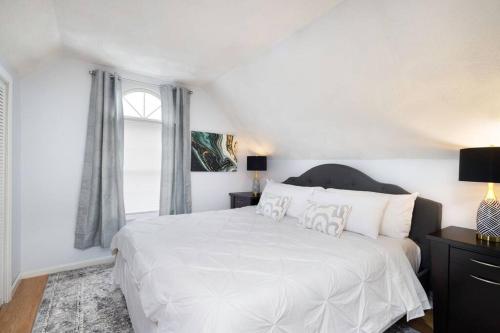 a white bedroom with a large bed and a window at Convenient Braintree Home - 3 Bedroom Sleeps 8 in Braintree
