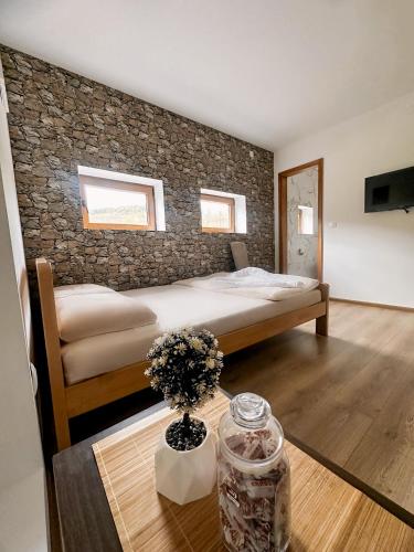 a bedroom with a large bed and a table with a table sidx sidx at Etno domaćinstvo Dvožak in Pluzine
