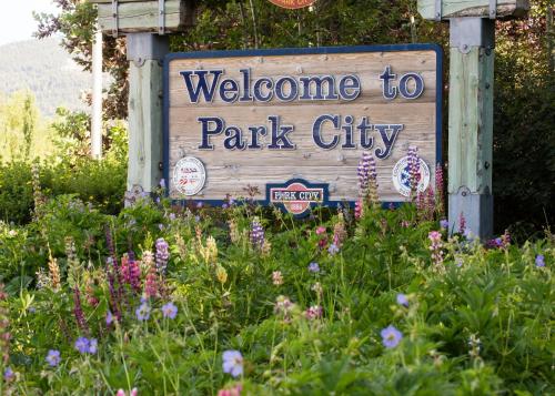 a welcome to park city sign in a field of flowers at Helling Circle Hideaway 303 condo in Heber City