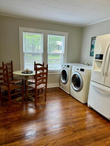 a kitchen with a table and a washer and dryer at Cozy Corner In The City in Hot Springs