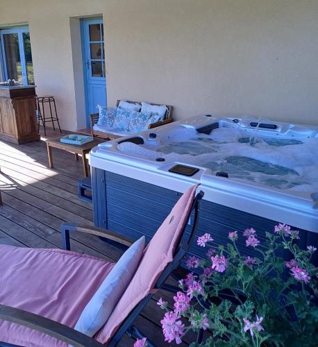 a bedroom with a bed and two chairs and flowers at Domaine du Boscq in Parleboscq