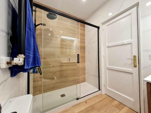 a shower with a glass door in a bathroom at Vincent's House in Barcelona