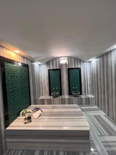a bathroom with a bath tub with three windows at Ulu Panorama Residence in Alanya
