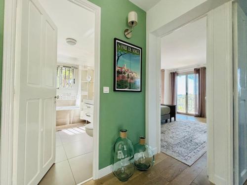 une salle de bain avec deux grands vases en verre au sol dans l'établissement Bastide de charme sous les pins avec piscine, à Saint-Paul-de-Vence